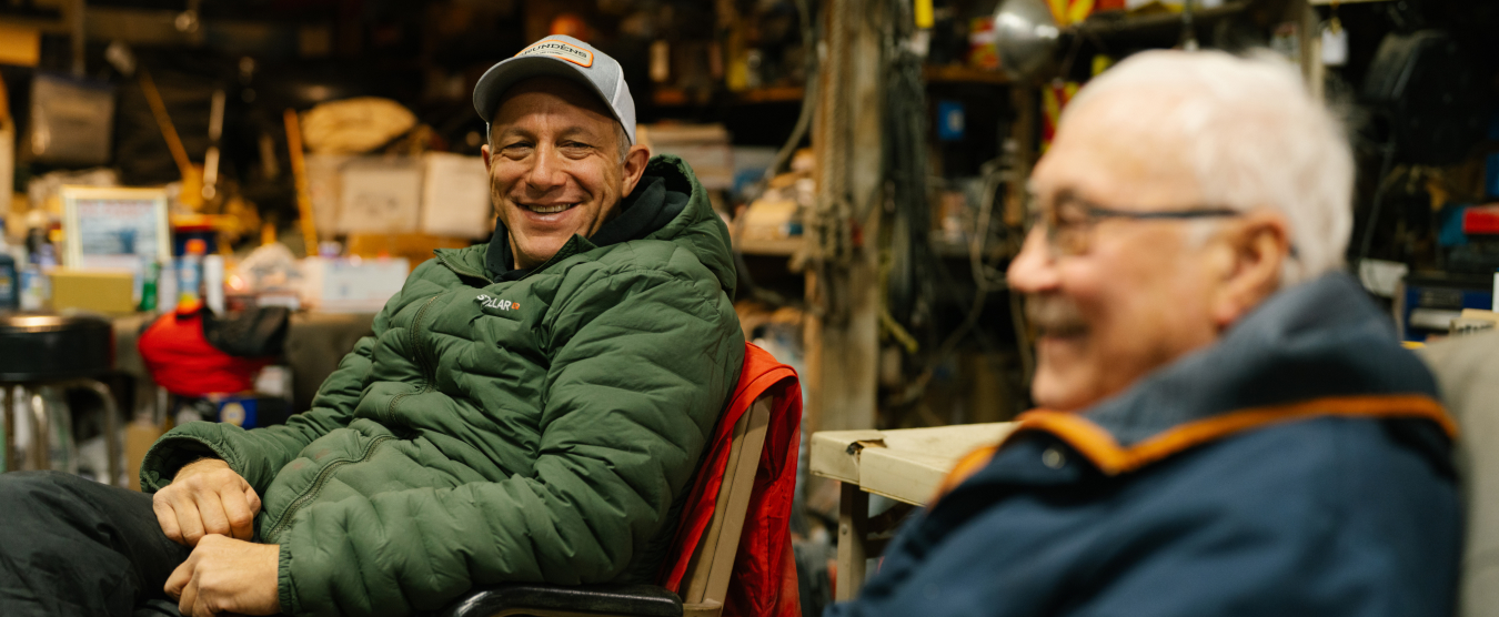 Bill Hill laughing with a community elder